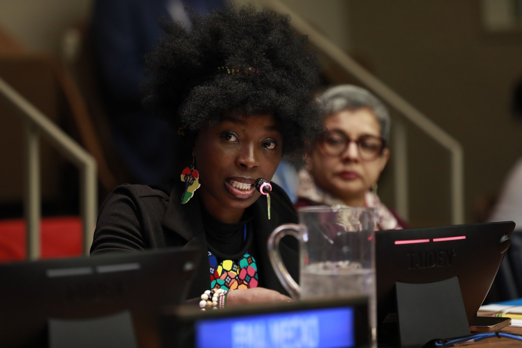 Eva Chisom Chukwunelo speaking into a microphone during a United Nations session