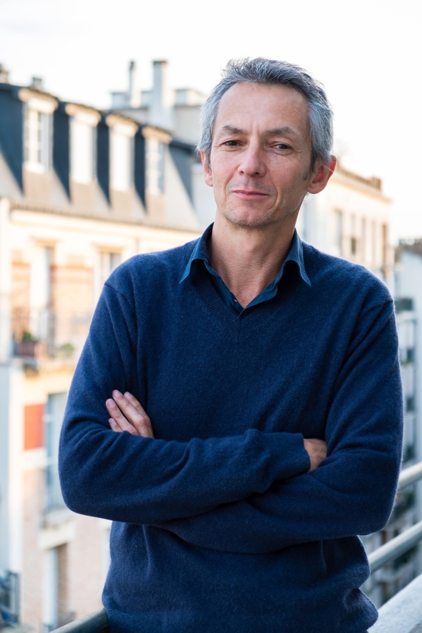 Frédéric Hovart on a Paris balcony, arms folded
