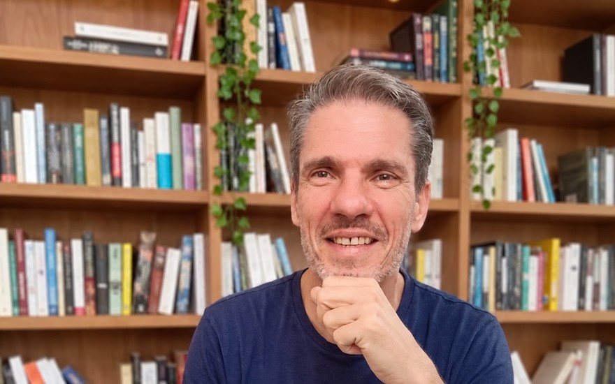 Patrice Marmouget devant sa bibliothèque