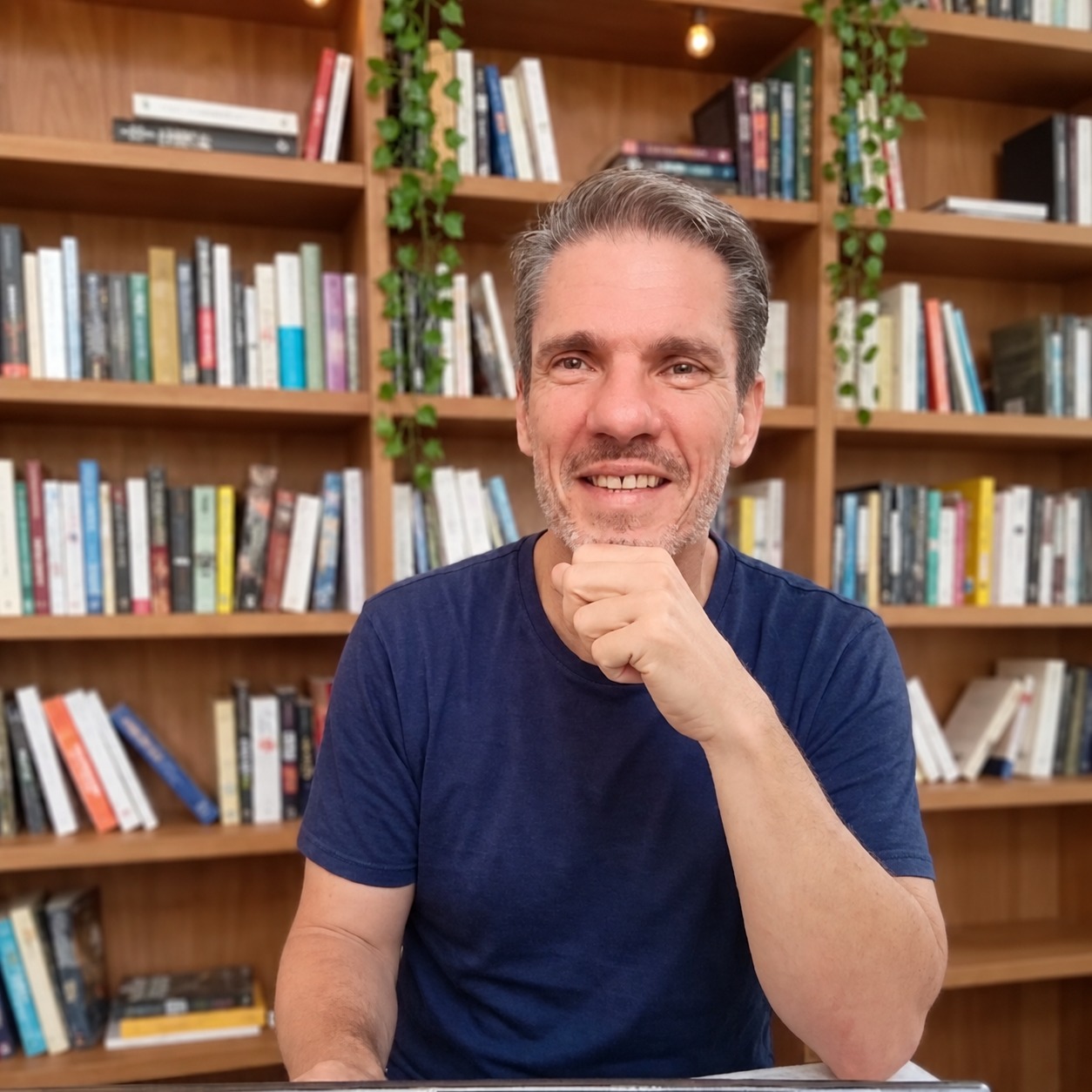 Patrice Marmouget in front of his bookshelves
